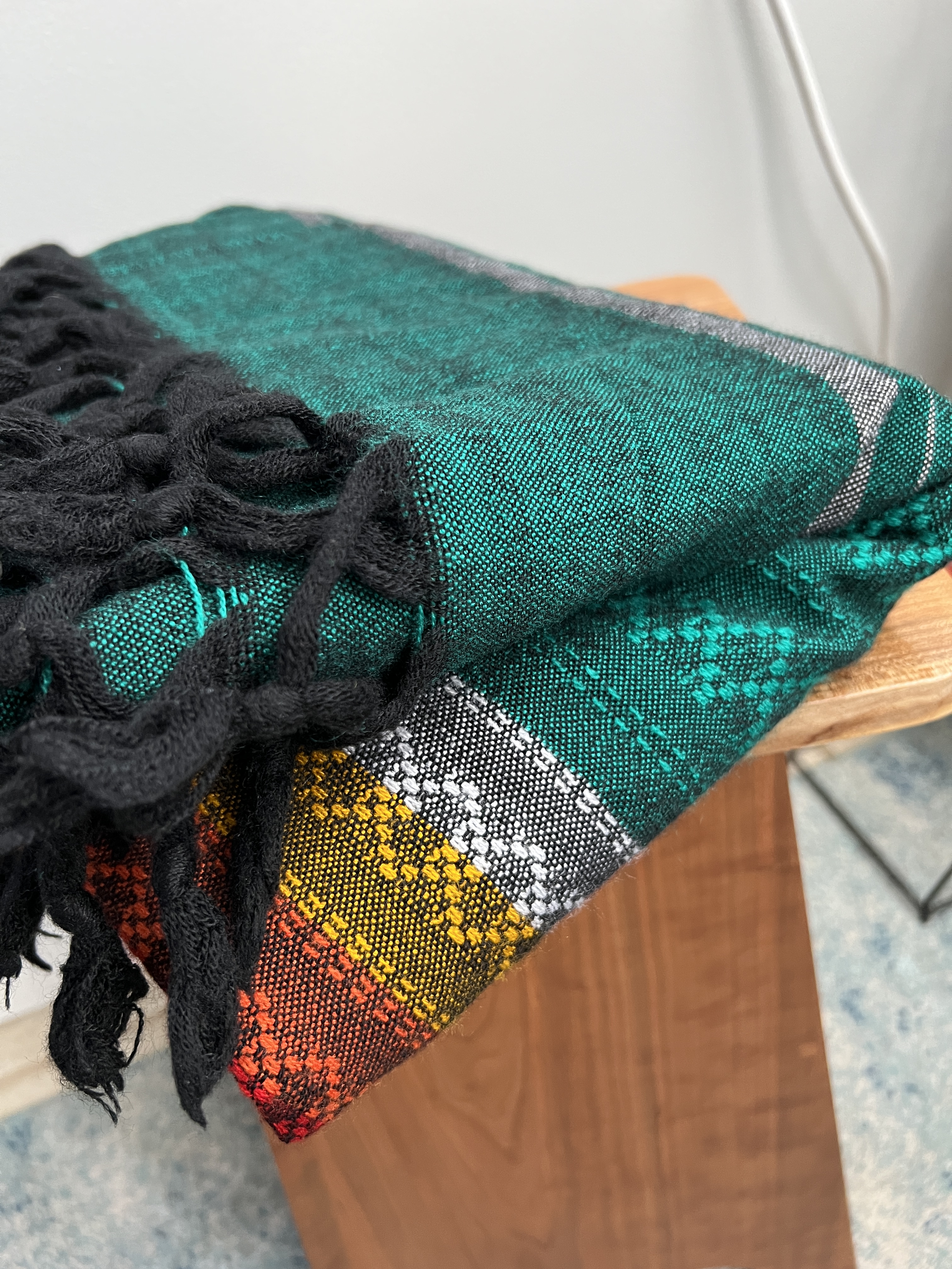 Multicolored, predominately green blanket made from Agave fibers