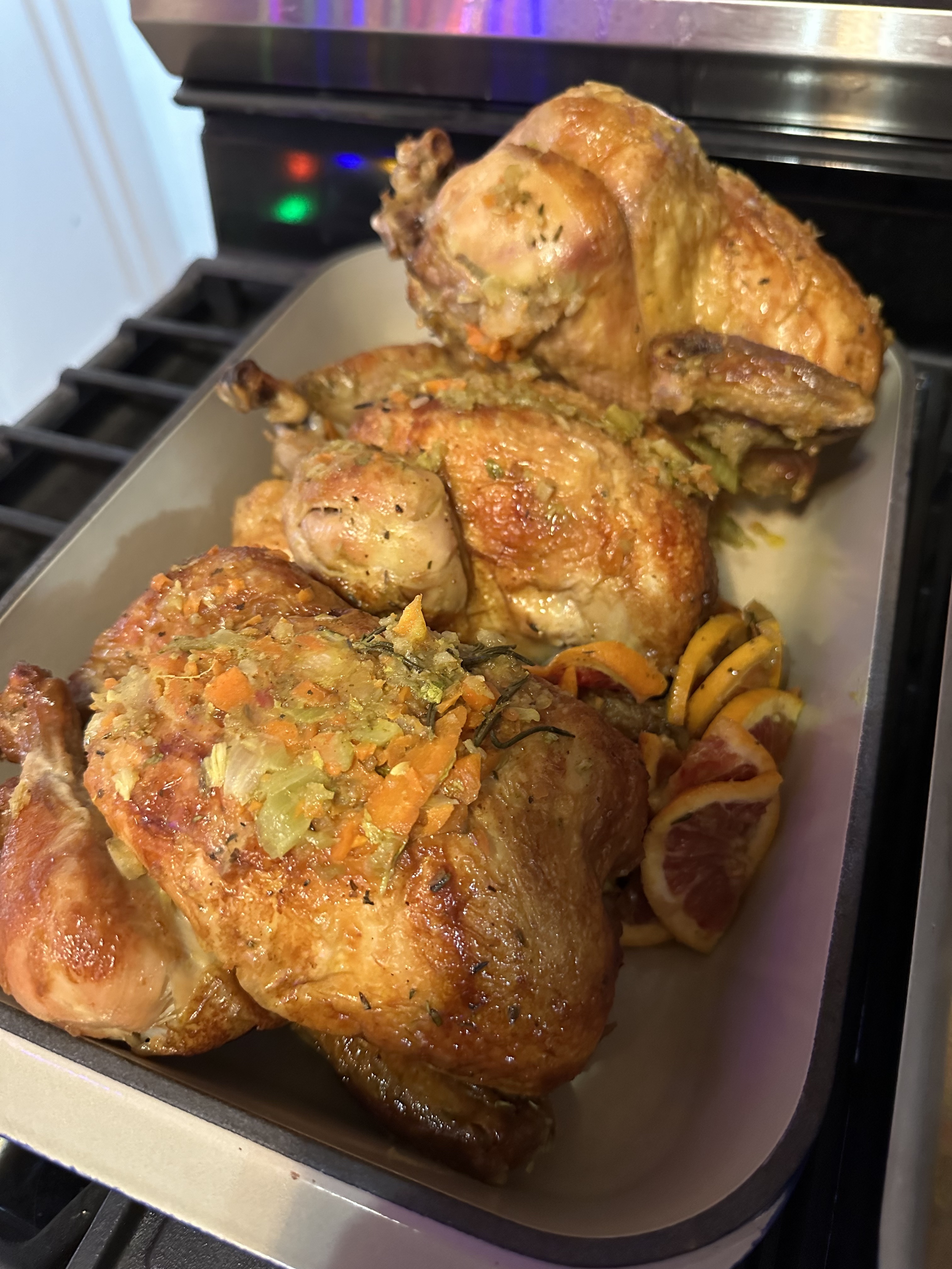 A baking dish with three roasted chickens